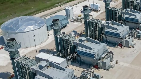 A graphic rendering of four natural gas generators next to a geodesic dome. The generators feature short exhaust stacks next to industrial grade machinery.