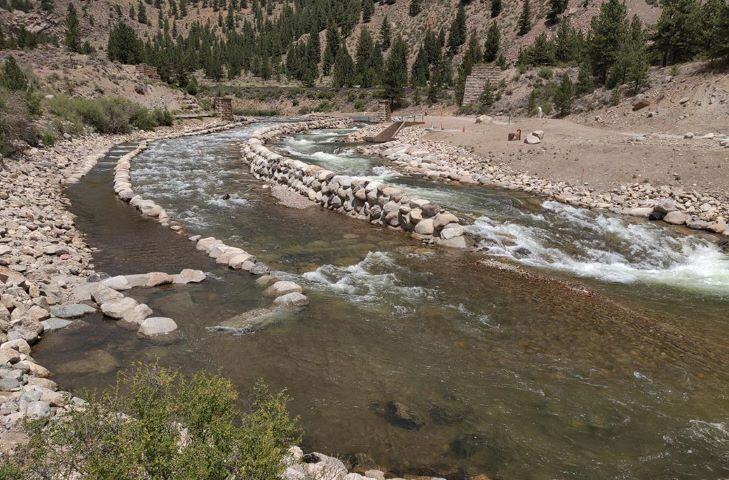 The Homestake Arkansas River Diversion. The diversion is made of stone walls. Trees dot the hillside in the background.