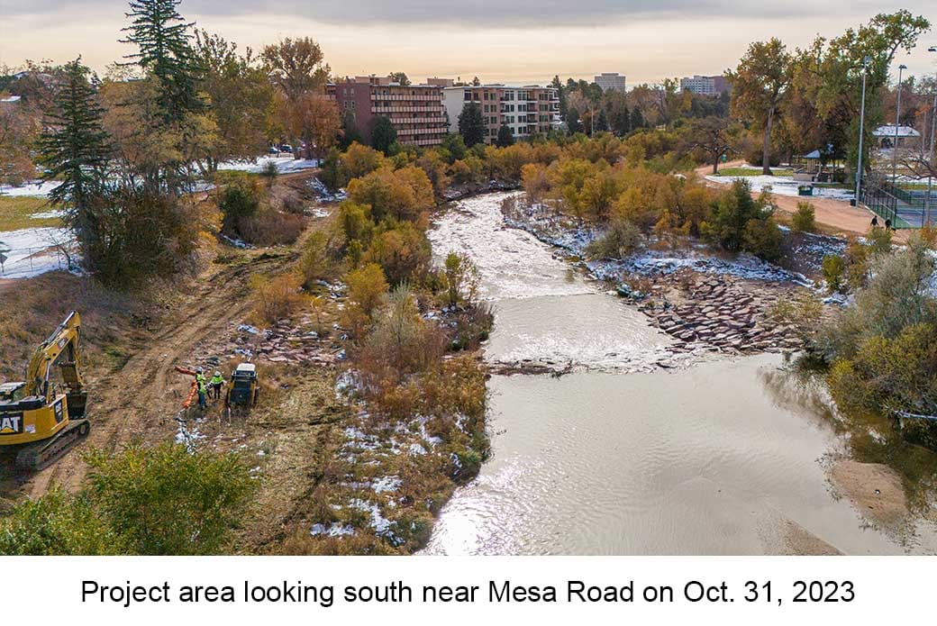 Aerial photo taken on Oct. 31, 2023 shows construction along Monument Creek. An excavator and 3 workers are visible on the bank of the creek.