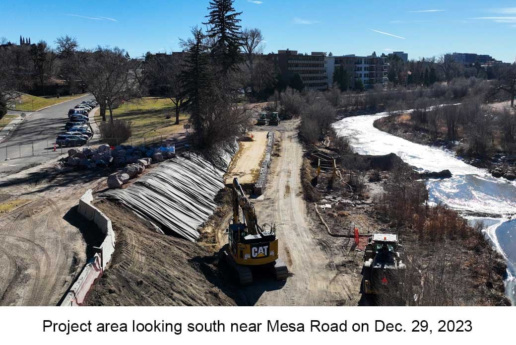 Aerial photo of Monument Creek near Colorado College taken on December 29, 2023. An excavator and workers are visible near the water.