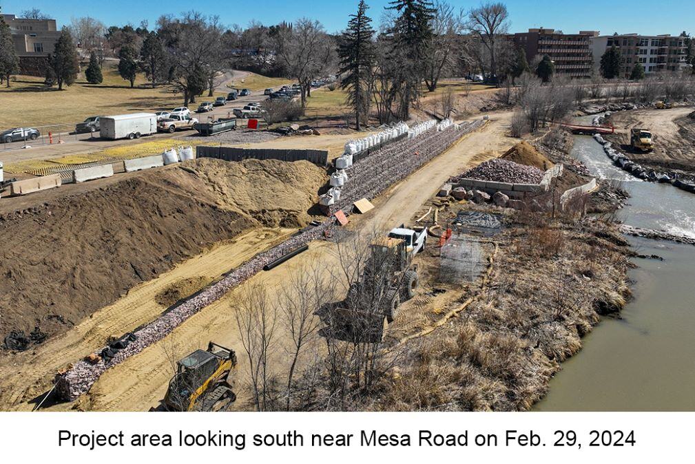 Aerial photo of Monument Creek near Mesa Road on Feb. 29, 2023. An excavator and truck, are parked between the creek & a newly built rock wall.