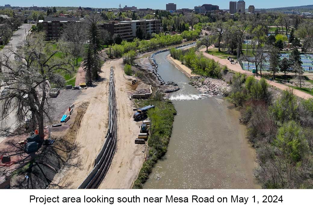 Aerial photo of Monument Creek near Mesa Road on May 1, 2024. A truck is parked between boulders in the creek and a newly constructed wall.